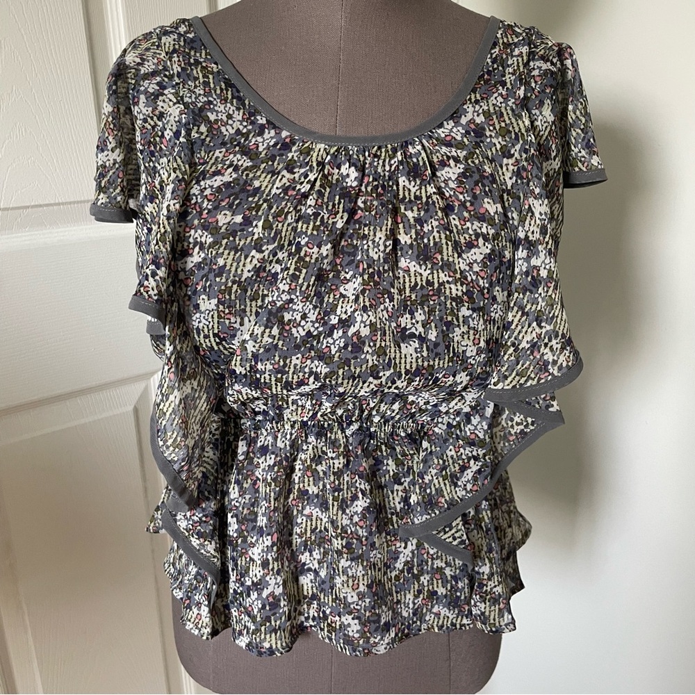 Scoop neck peplum top with vertical ruffles